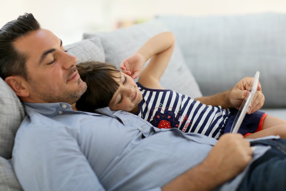 Daddy with little girl playing with tablet