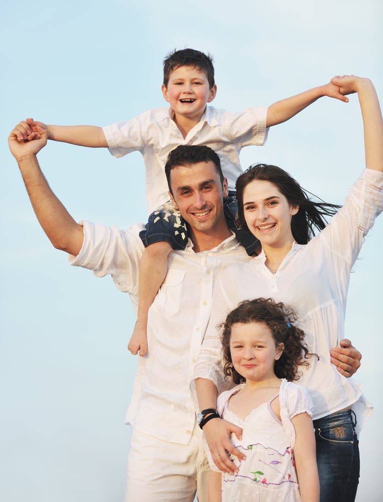 happy young family have fun and live healthy lifestyle on beach